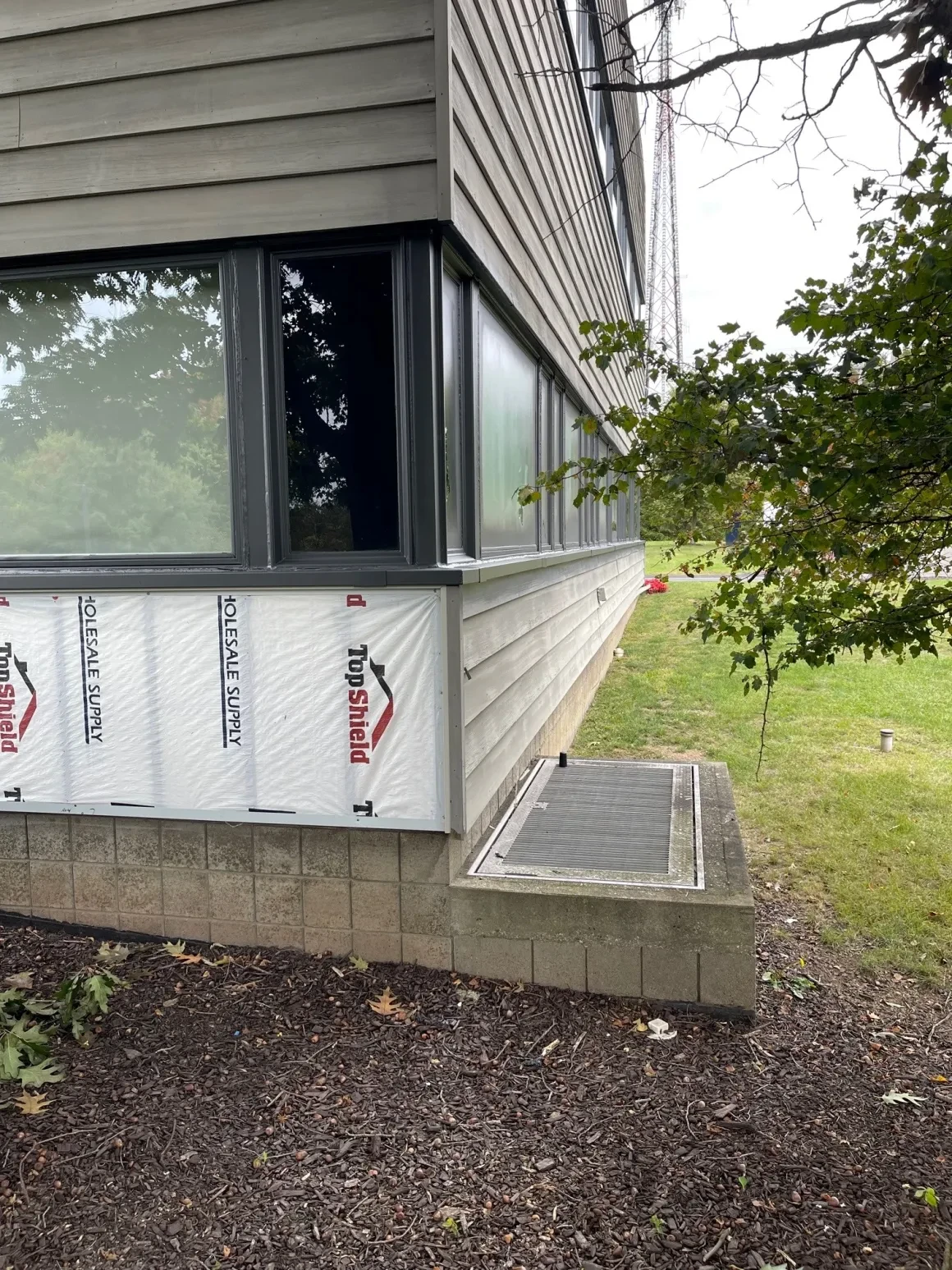 TopShield weather barrier installed on commercial building corner during renovation
