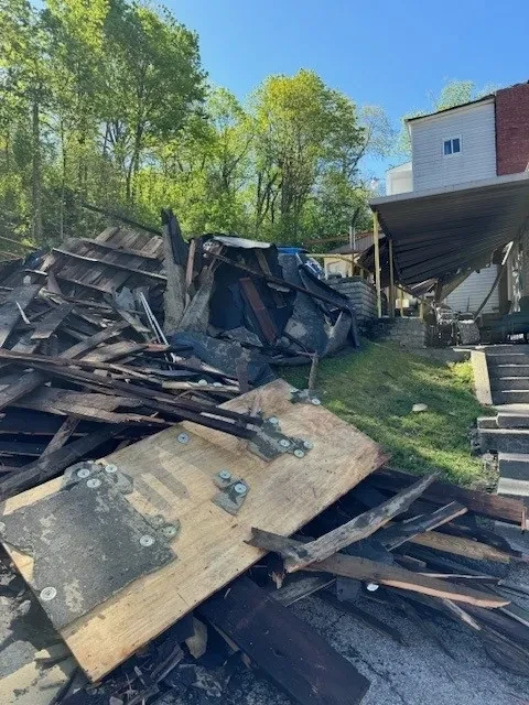 Storm debris pile — collapsed roof materials removed from site