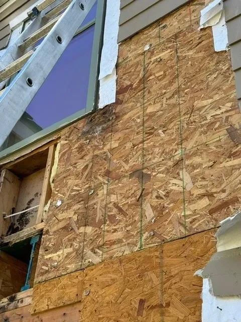 Exposed OSB sheathing with water damage and deterioration
