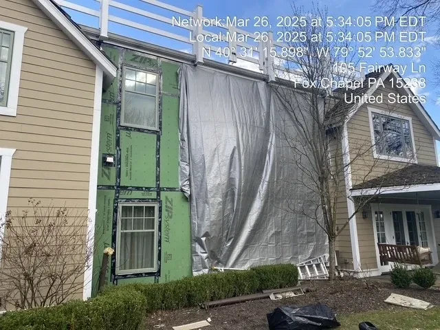 Exterior wall with ZIP System sheathing and tarp protection during remediation